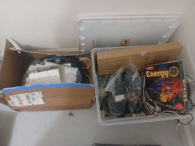 Box and bin with computer cords and random computer supplies image