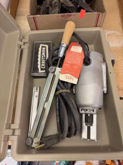 chainsaw sharpener and a box of tools image
