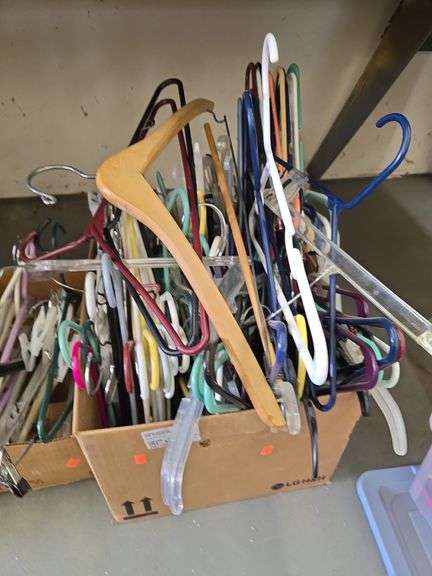 Boxes of hangers and a bag of metal organizers image