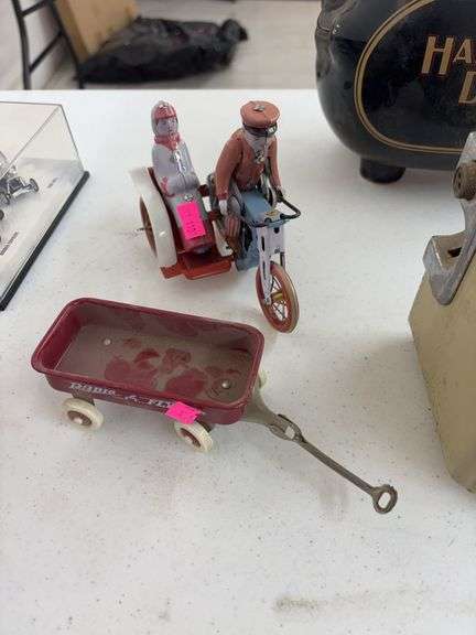 vintage-style tin wind-up toy motorcycle with a sidecar and miniature radio flyer image