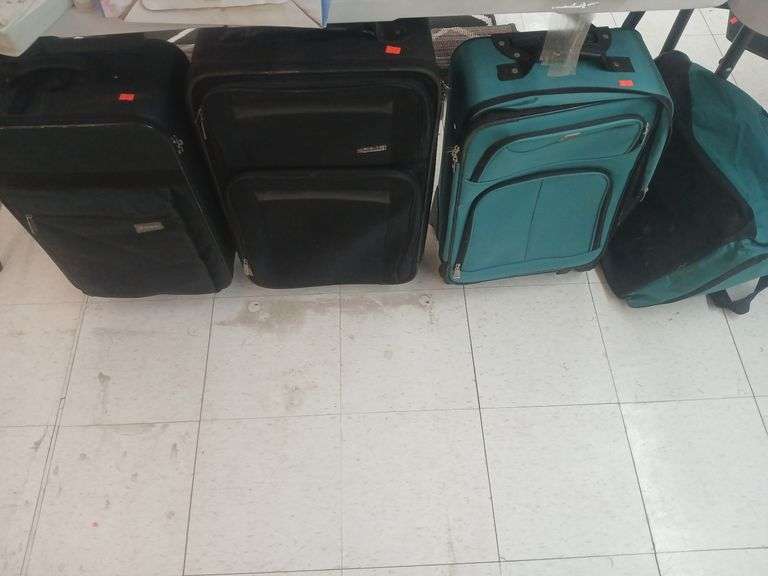 3 suitcases and a duffle bag image