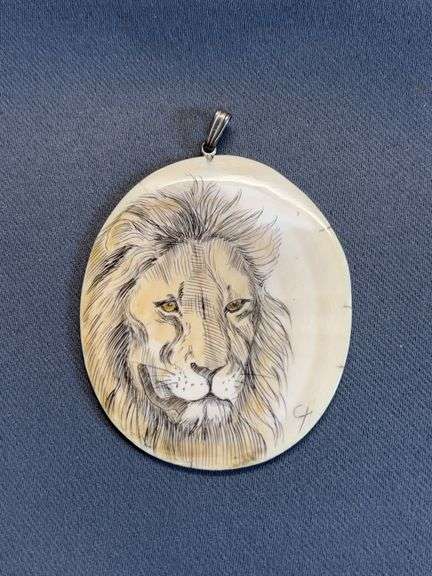 Lion etched ivory pendant image