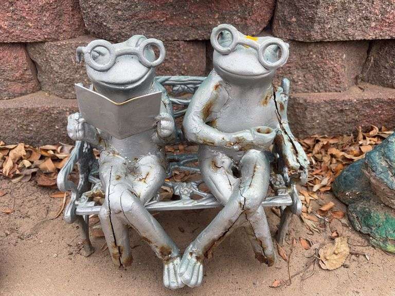 Metal frogs on a bench yard decoration image
