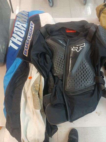 Fox dirtbike vest and thor dirtbike pants. image
