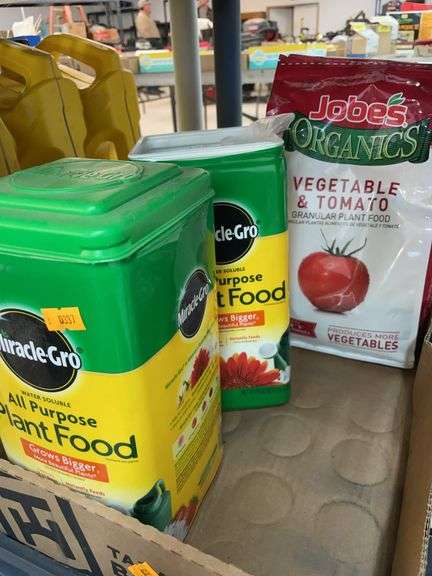 Lot of miracle grow plant food, vegetable, and tomato food image