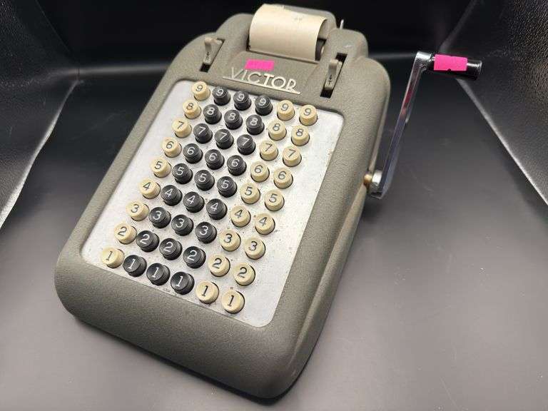 Victor adding machine with paper rolls. image