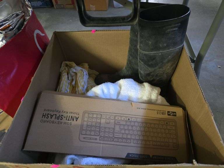 Box of blankets, rubber boots, and a keyboard image