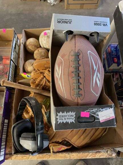 Two boxes of baseball gloves, baseballs, softballs, and a football image