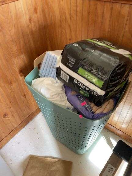 Basket of adult diapers and pads. image