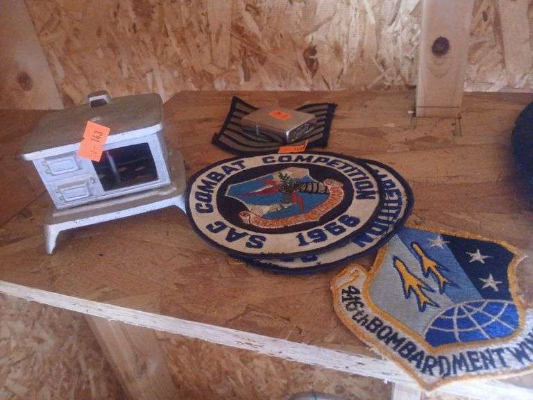 Military patches, zippo, stove shelf decor. image