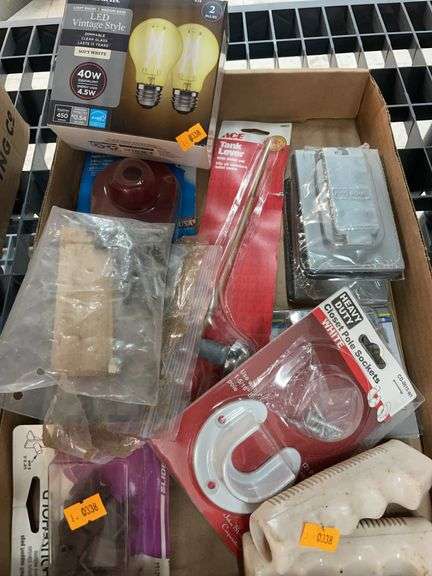 A box containing lightbulbs, toilet parts, miscellaneous hardware and electrical outlet covers image
