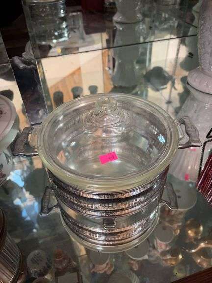 Vintage Pyrex glass casserole dish with a metal serving caddy image