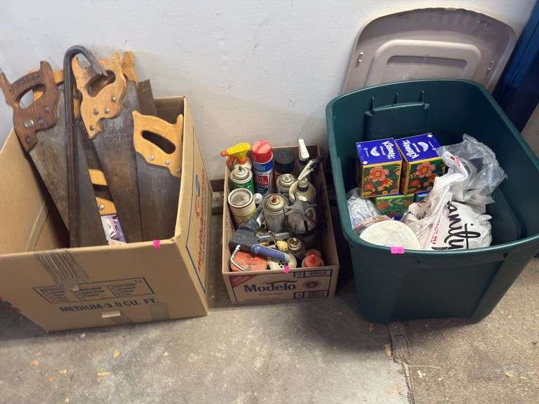 Three boxes, hand, saws, prybar, assorted chemicals, paper, towel, towels, Kleenexes, image