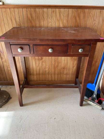 Small wooden three drawer table. image