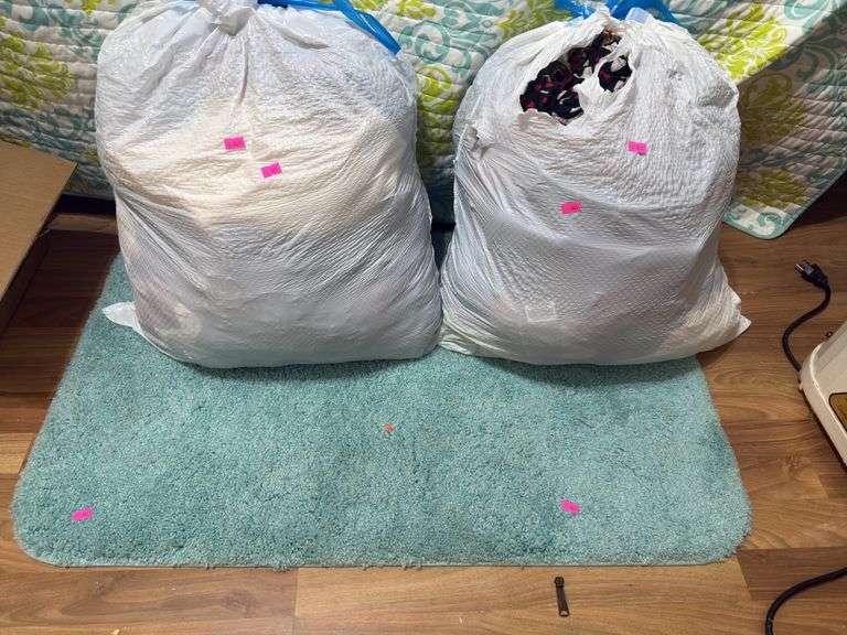2 bags of clothes and a bath mat image