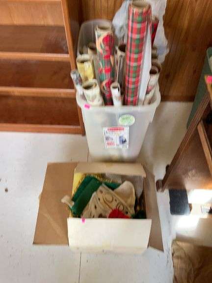 Three plastic totes of Christmas paper and one box of miscellaneous Christmas items image