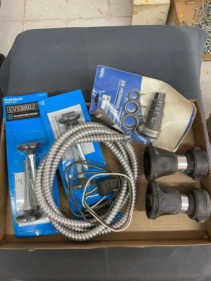 Box containing garage door rollers, dishwasher connector kit, electrical and sprayers image