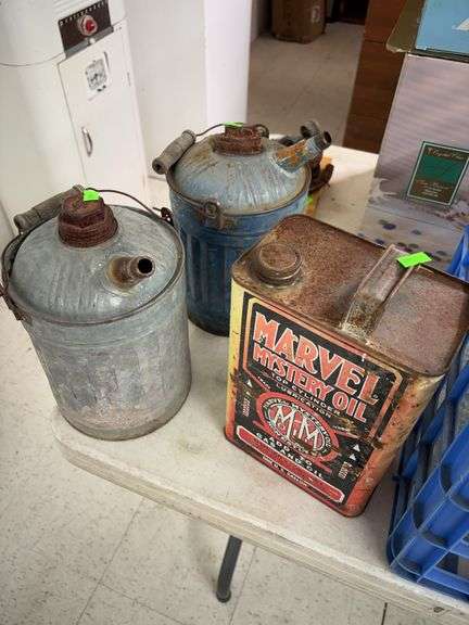 vintage galvanized metal gas cans and Marvel mystery oil can image