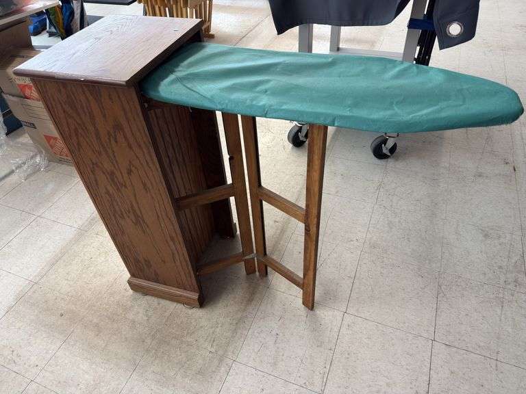 Fold out ironing board cabinet. image
