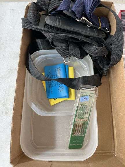 Box of old pictures, straps, coin protectors and plastic containers.