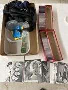 Box of old pictures, straps, coin protectors and plastic containers.