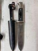 2 knives and a wooden sign.