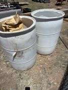 Two White Plastic Storage Barrels