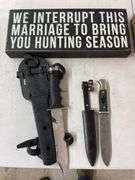 2 knives and a wooden sign.