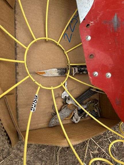 Old keys, wire basket, knives, and gun scabbard