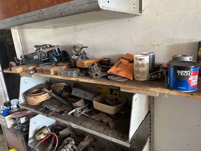 Four shelves of miscellaneous hardware, tools, and scrap metal