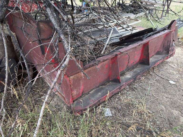 Dump truck bed with assortment of steel items in it.