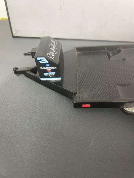 die-cast model of Dale Earnhardt's #3 Goodwrench NASCAR Lumina, which appears to be a 1:24 scale model, and it is depicted with a flatbed trailer.