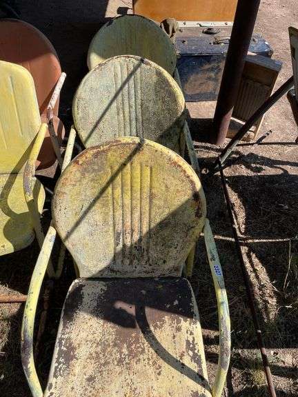 Three yellow metal patio chairs