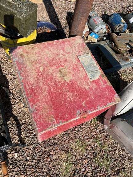 Red metal box containing a box of vintage dishes
