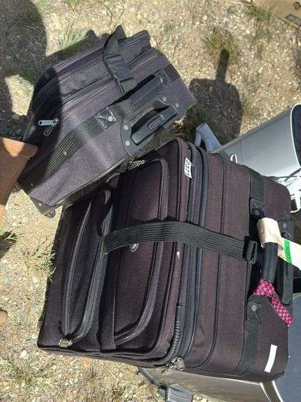 Two Black Rolling Suitcases