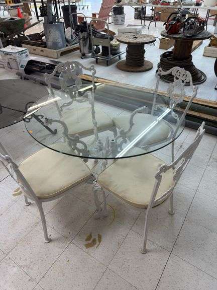 Glass top patio table with wrought iron chairs and table base image