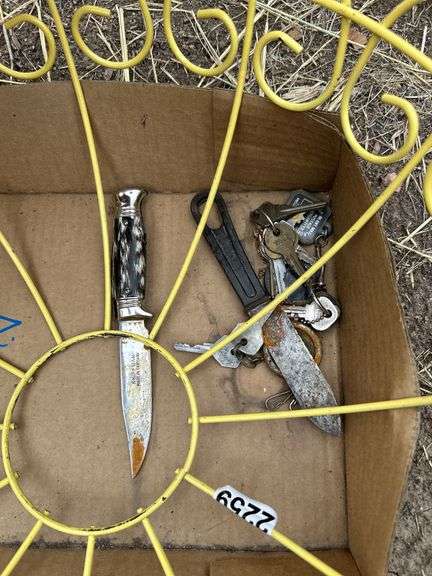 Old keys, wire basket, knives, and gun scabbard