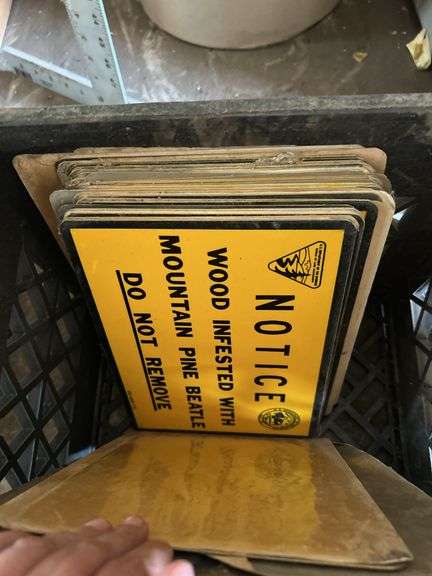 Crate of license plates, small Signs and gas pump handle
