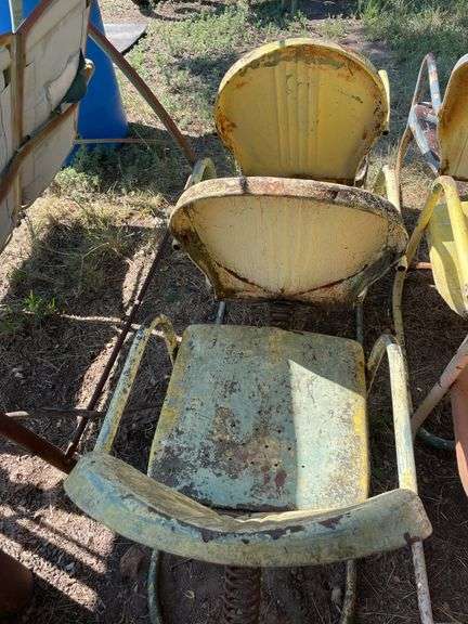 Three yellow metal patio chairs