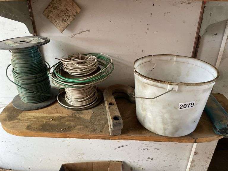 Contents of shelf. Miscellaneous wire hardware and a drill. image