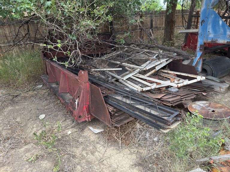 Dump truck bed with assortment of steel items in it. image