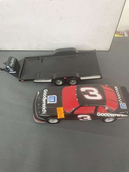 die-cast model of Dale Earnhardt's #3 Goodwrench NASCAR Lumina, which appears to be a 1:24 scale model, and it is depicted with a flatbed trailer.
