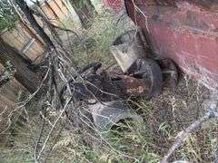 Dump truck bed with assortment of steel items in it.