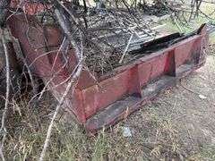 Dump truck bed with assortment of steel items in it.