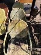 Three yellow metal patio chairs