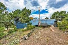 Colorado Mountain Property Auction • 5± (Two- 2.5 acres tracts)1 with Mobile Home and improvements, 1 land only