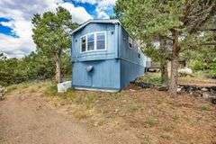 Colorado Mountain Property Auction • 5± (Two- 2.5 acres tracts)1 with Mobile Home and improvements, 1 land only