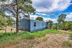 Colorado Mountain Property Auction • 5± (Two- 2.5 acres tracts)1 with Mobile Home and improvements, 1 land only