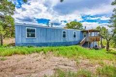 Colorado Mountain Property Auction • 5± (Two- 2.5 acres tracts)1 with Mobile Home and improvements, 1 land only