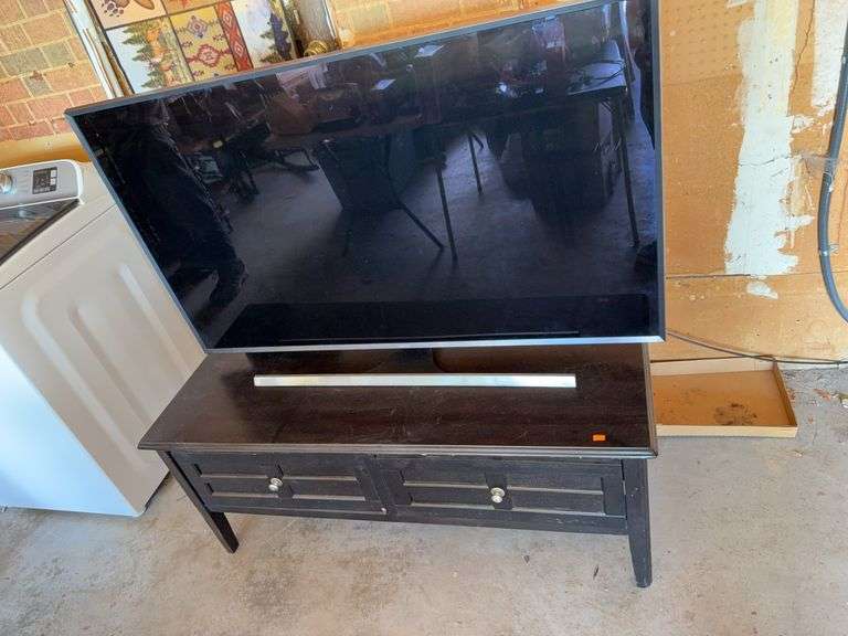50 inch Samsung flat screen TV (has Remote) with table it is on image